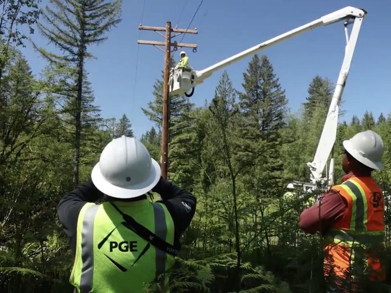 PGE crew working on a power line in a forest